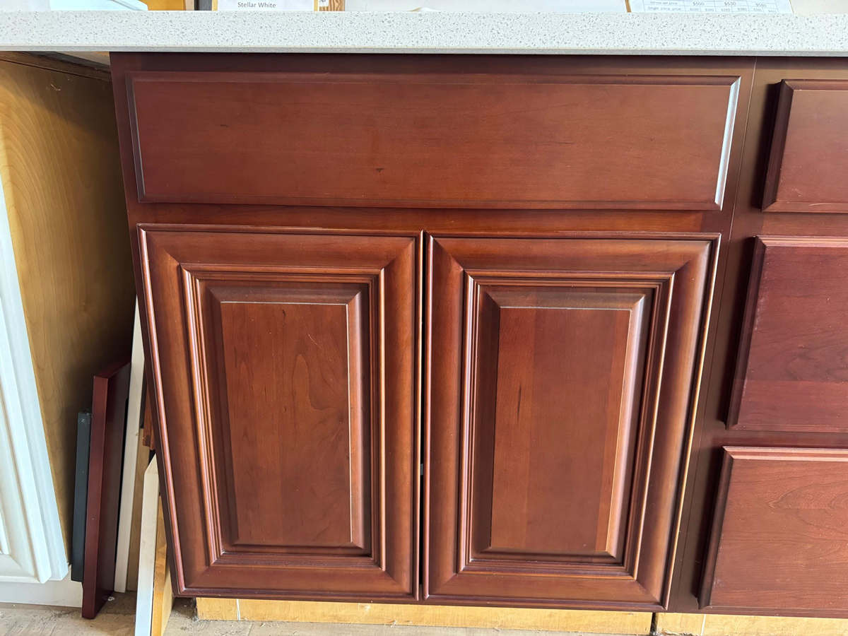 Cherry raised panel style cabinets