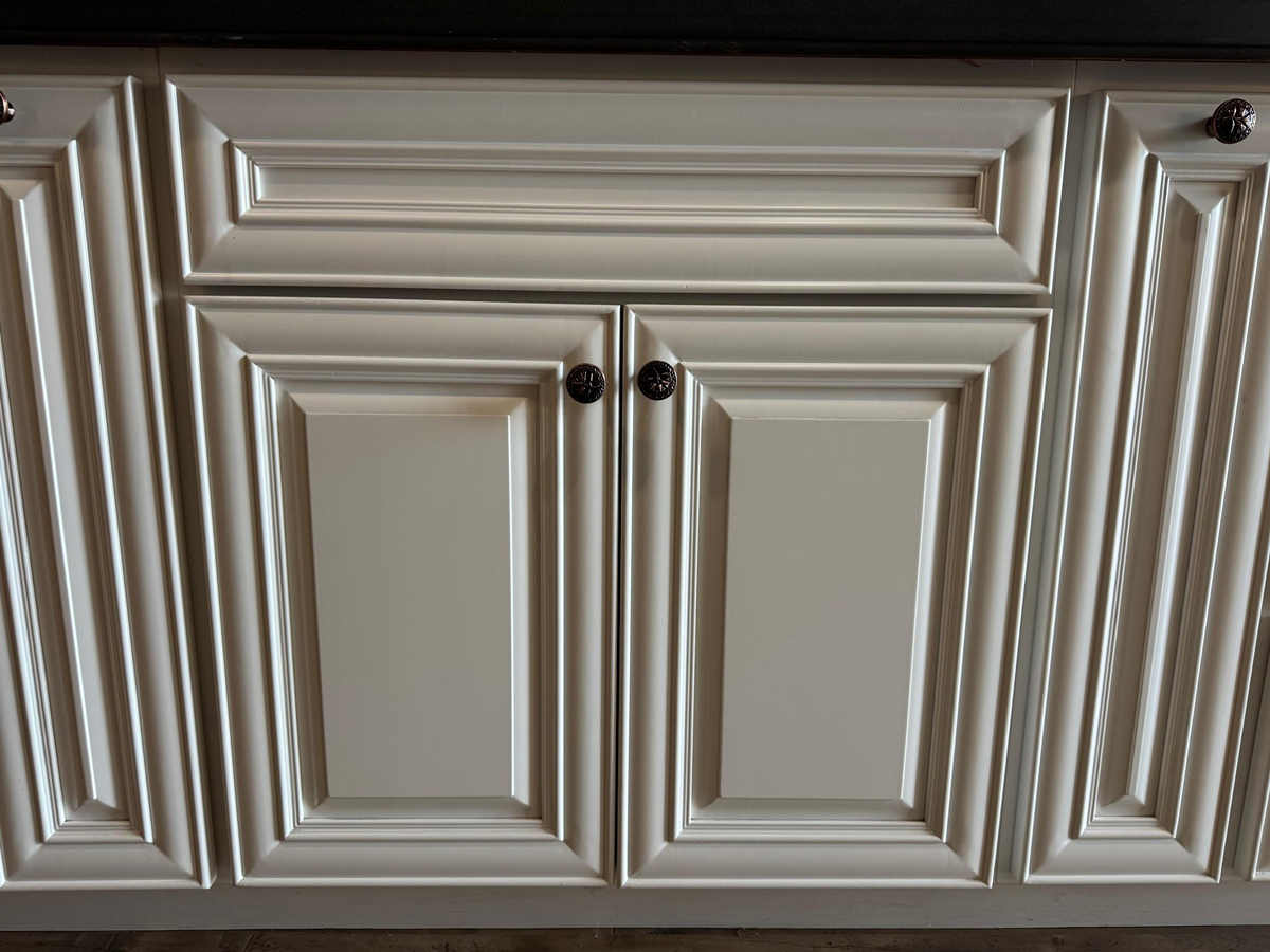 White raised panel style cabinets